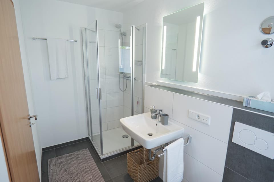 Shower, Toilet, Bathroom, hair dryier, towels, washing machine, dryer