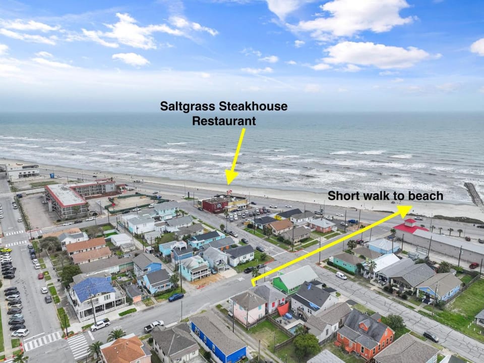 Property building, Nearby landmark, Day, Neighbourhood, Natural landscape, Bird's eye view, Beach, Text overlay, City view, Sea view, Street view