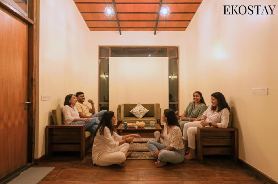 People, Living room, Seating area, Text overlay, group of guests