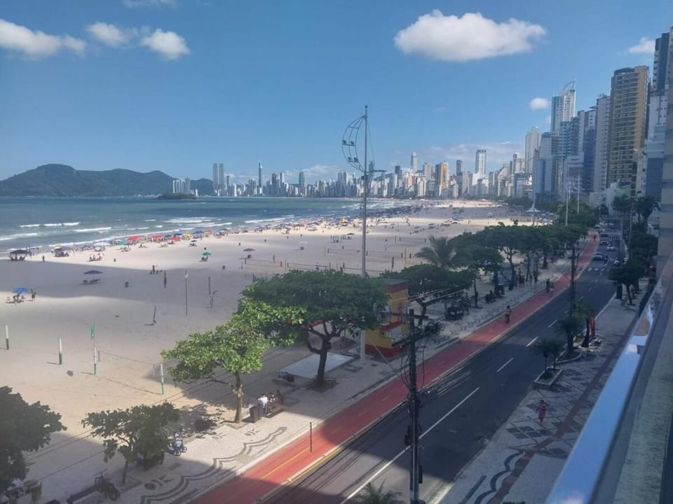 Building facing the sea Side view of Ferris Wheel Apartment in Camboriú