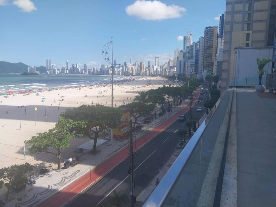 Building facing the sea Side view of Ferris Wheel Apartment in Camboriú
