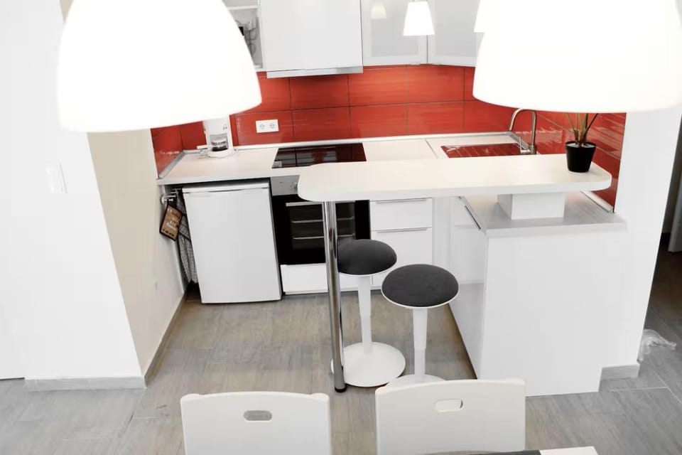 Kitchen or kitchenette, dishwasher, oven, stove