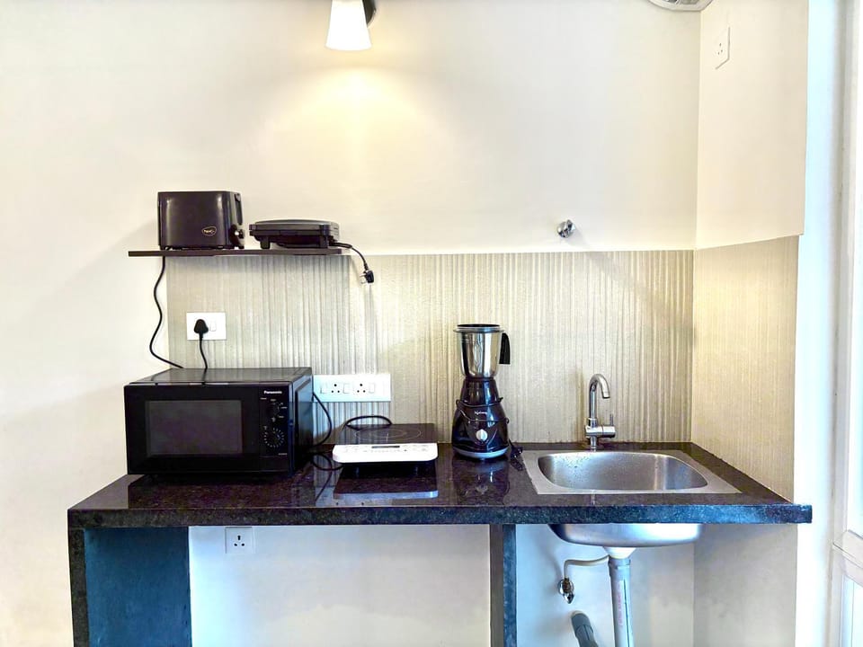 Kitchen or kitchenette, microwave, stove, toaster