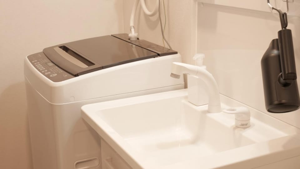 Photo of the whole room, hair dryier, laundry, washing machine