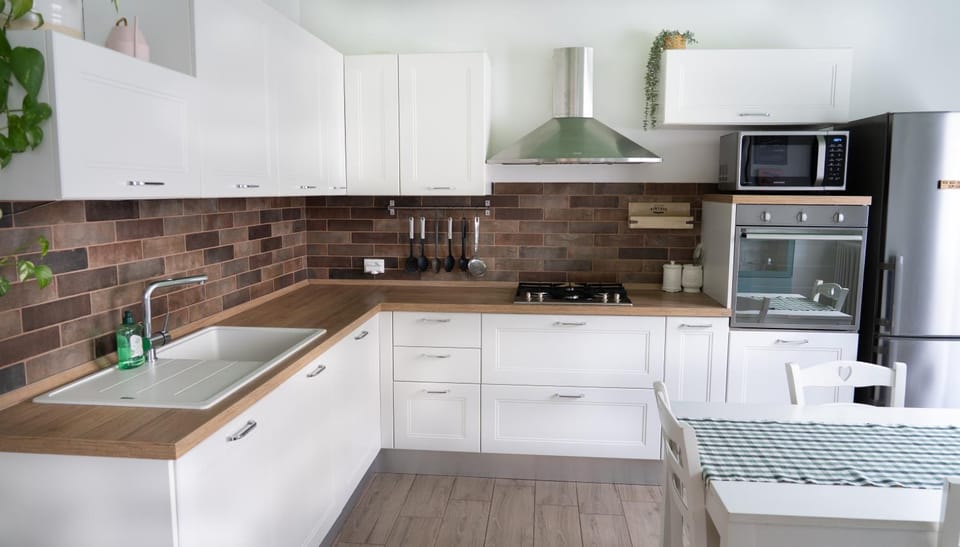 Kitchen or kitchenette, dishwasher, oven, stove