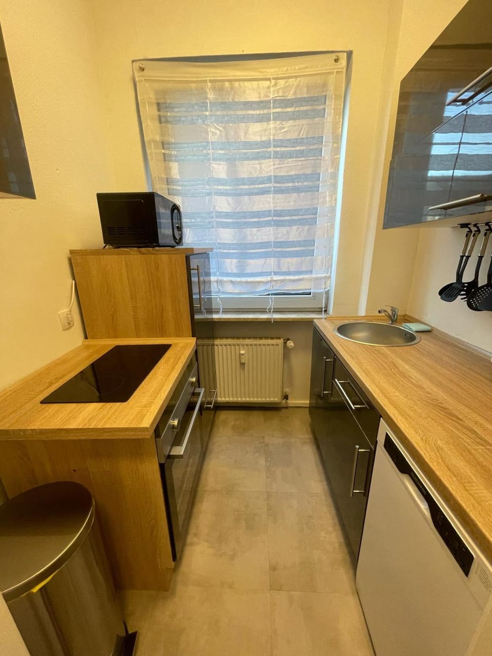 Kitchen or kitchenette, dishwasher, oven, stove