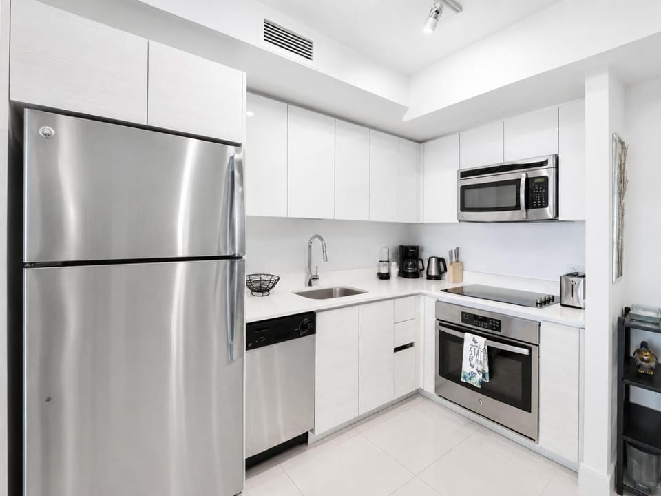 Kitchen or kitchenette, dishwasher, microwave, oven, stove