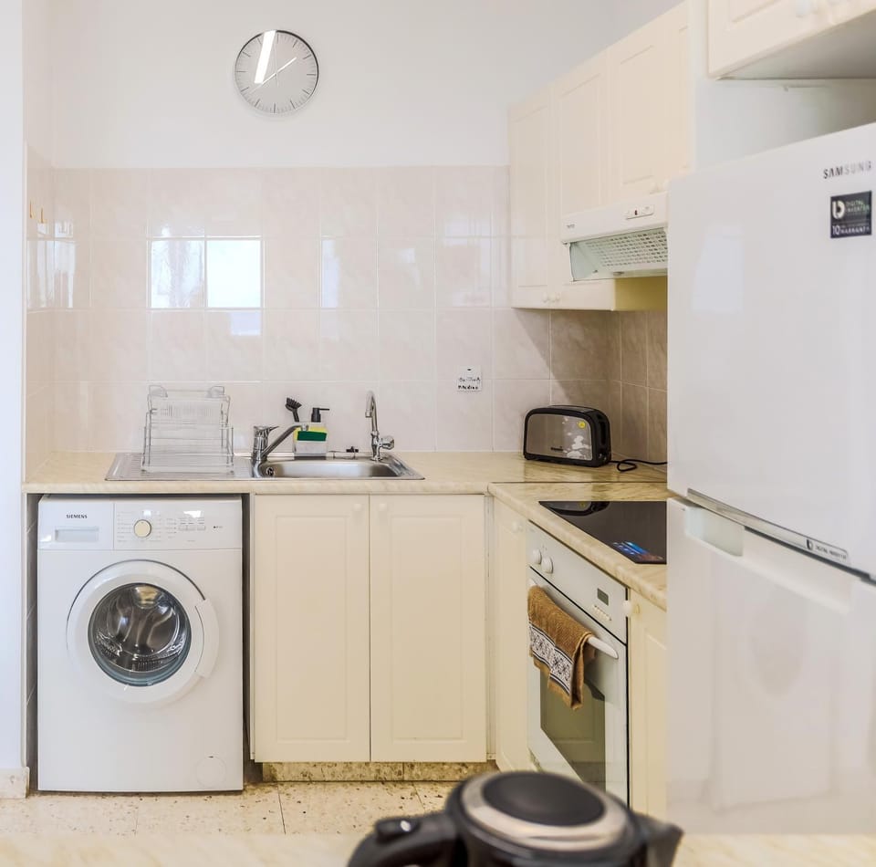 Kitchen or kitchenette, oven, stove, toaster, washing machine