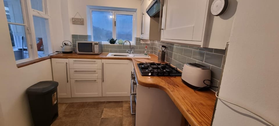 Kitchen or kitchenette, microwave, stove, toaster