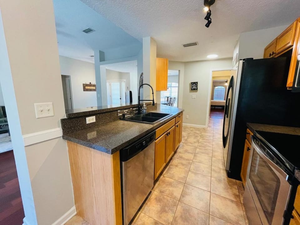 Kitchen or kitchenette, dishwasher, oven, stove