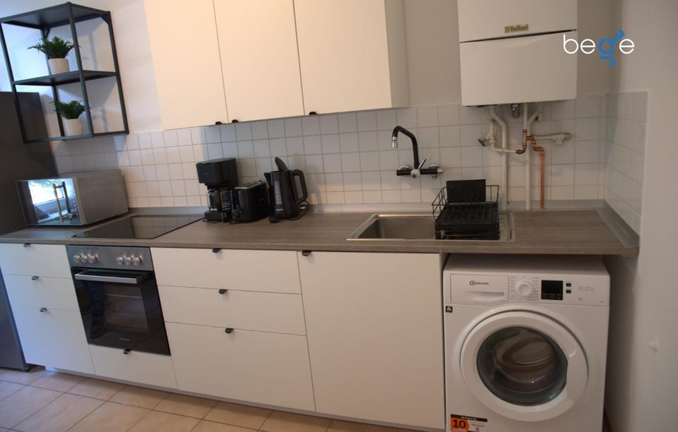 Kitchen or kitchenette, dishwasher, oven, stove, toaster, washing machine