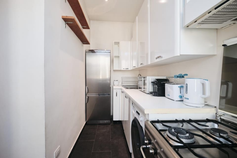 Kitchen or kitchenette, dishwasher, microwave, oven, stove, toaster, washing machine