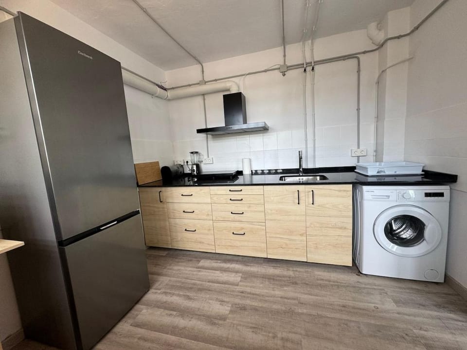 Kitchen or kitchenette, oven, stove, washing machine