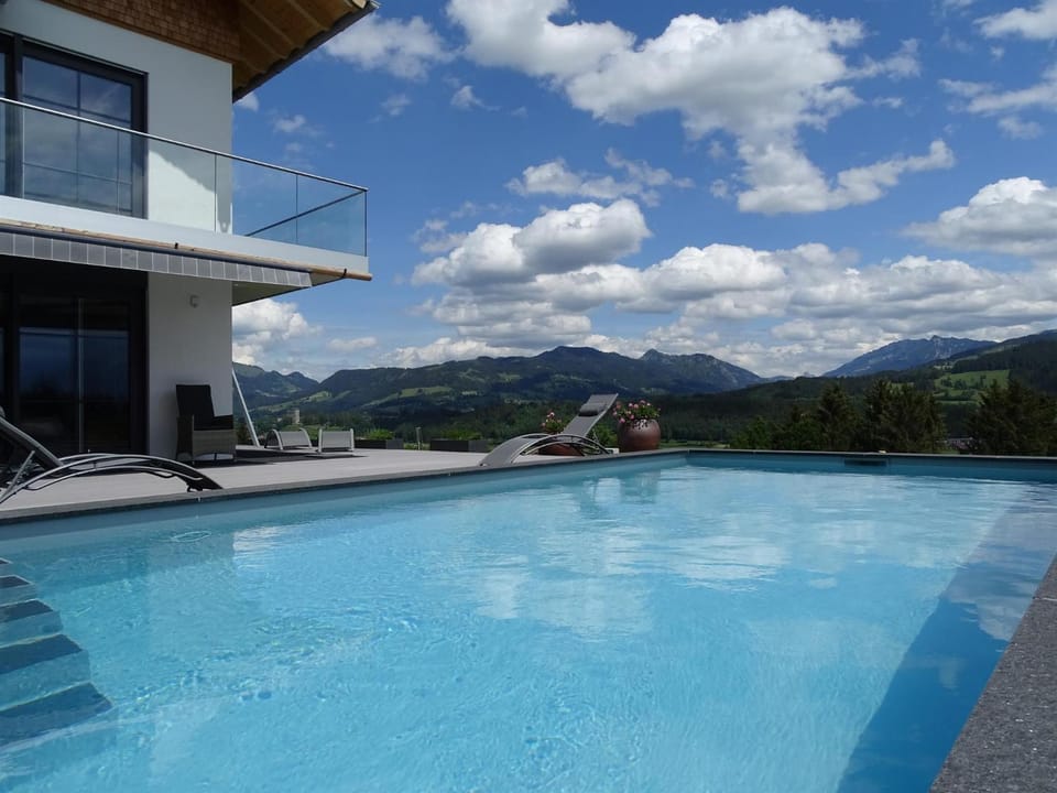 Property building, Nearby landmark, Day, Natural landscape, Mountain view, Pool view, Swimming pool, sunbed