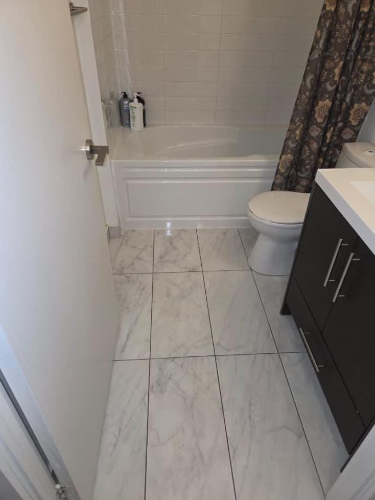 Condo with grey sofa bed Apartment in Port Hope