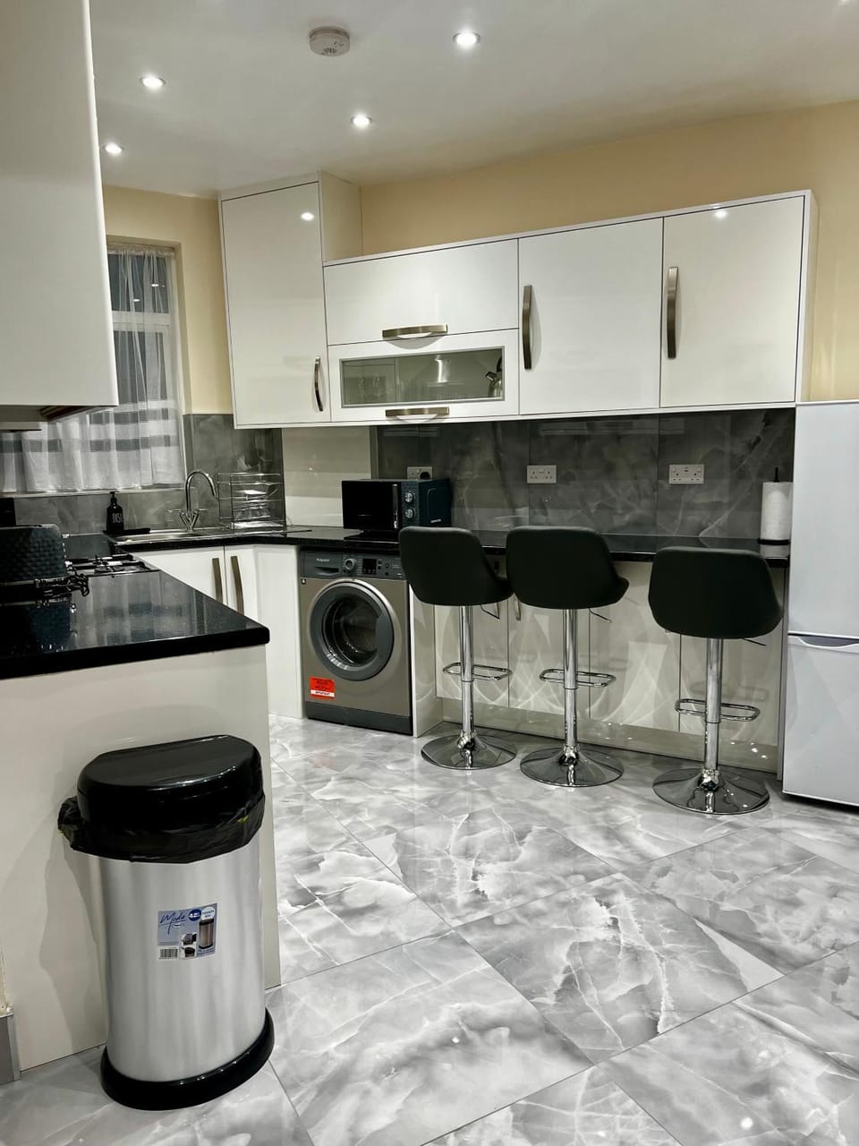 Kitchen or kitchenette, microwave, oven, stove, toaster, washing machine