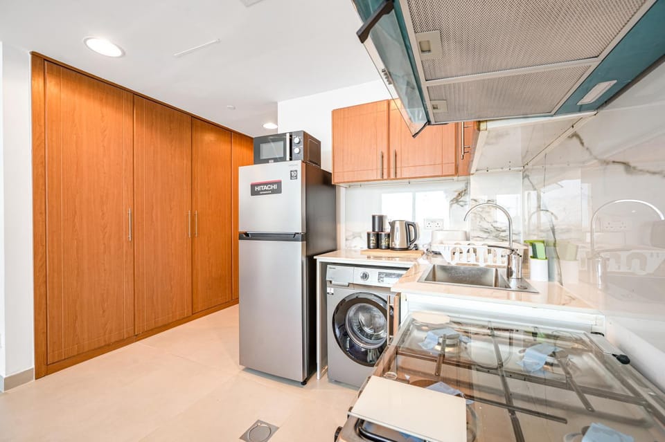 Kitchen or kitchenette, oven, stove, toaster, washing machine