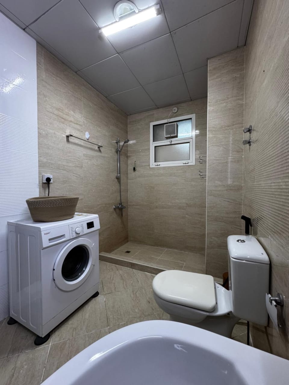 Shower, Toilet, Bathroom, bidet, towels, washing machine, dryer