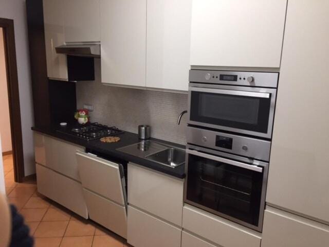 Kitchen or kitchenette, dishwasher, oven, stove