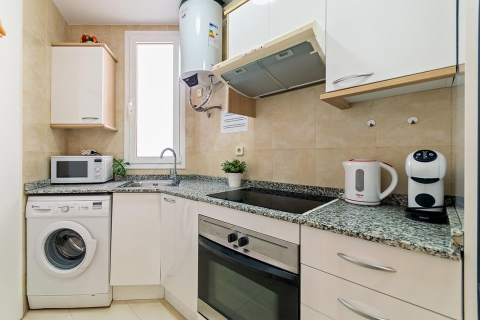 Kitchen or kitchenette, oven, stove, washing machine
