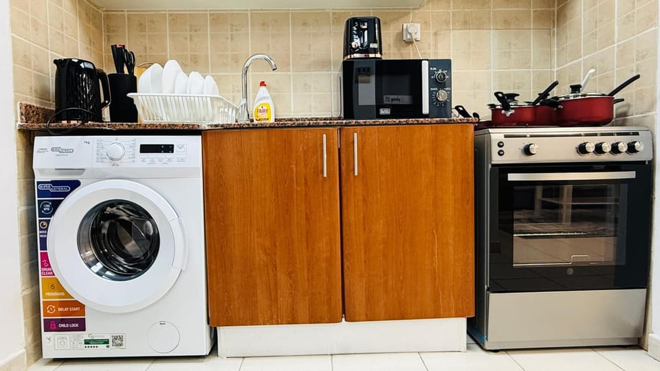 Kitchen or kitchenette, dishwasher, oven, stove, toaster, washing machine
