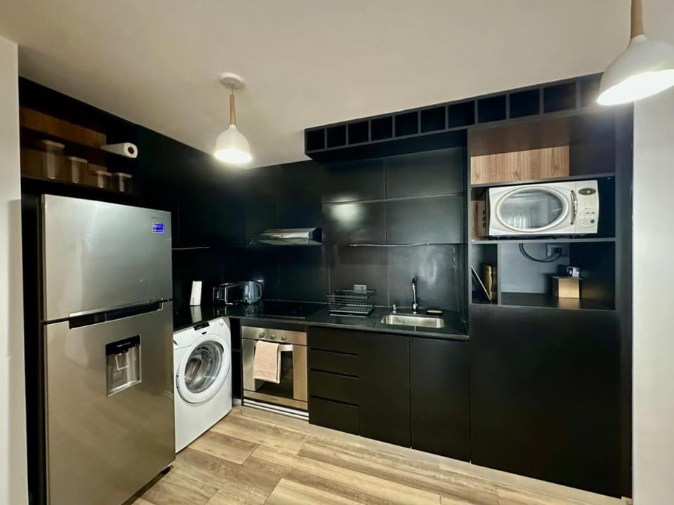 Kitchen or kitchenette, minibar, oven, stove, toaster, washing machine