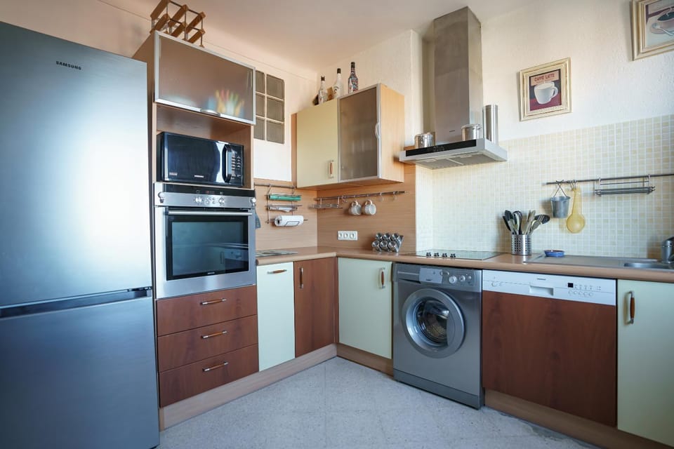Kitchen or kitchenette, dishwasher, oven, stove, toaster, washing machine