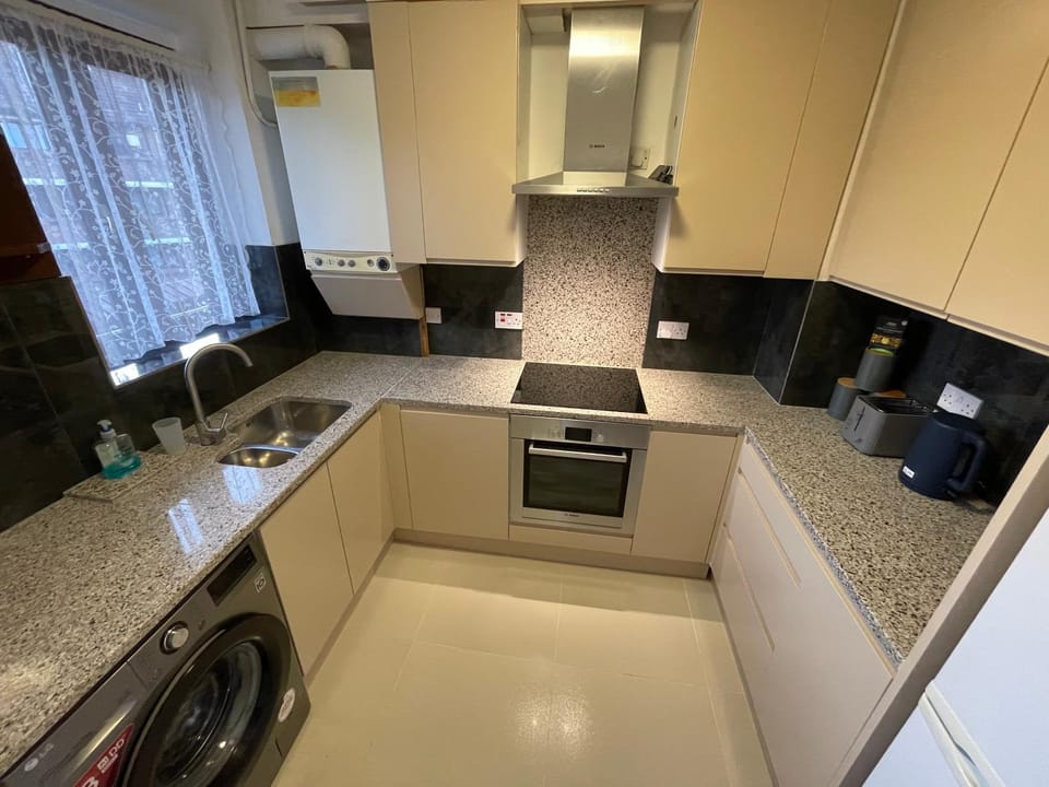 Kitchen or kitchenette, oven, stove, toaster, washing machine