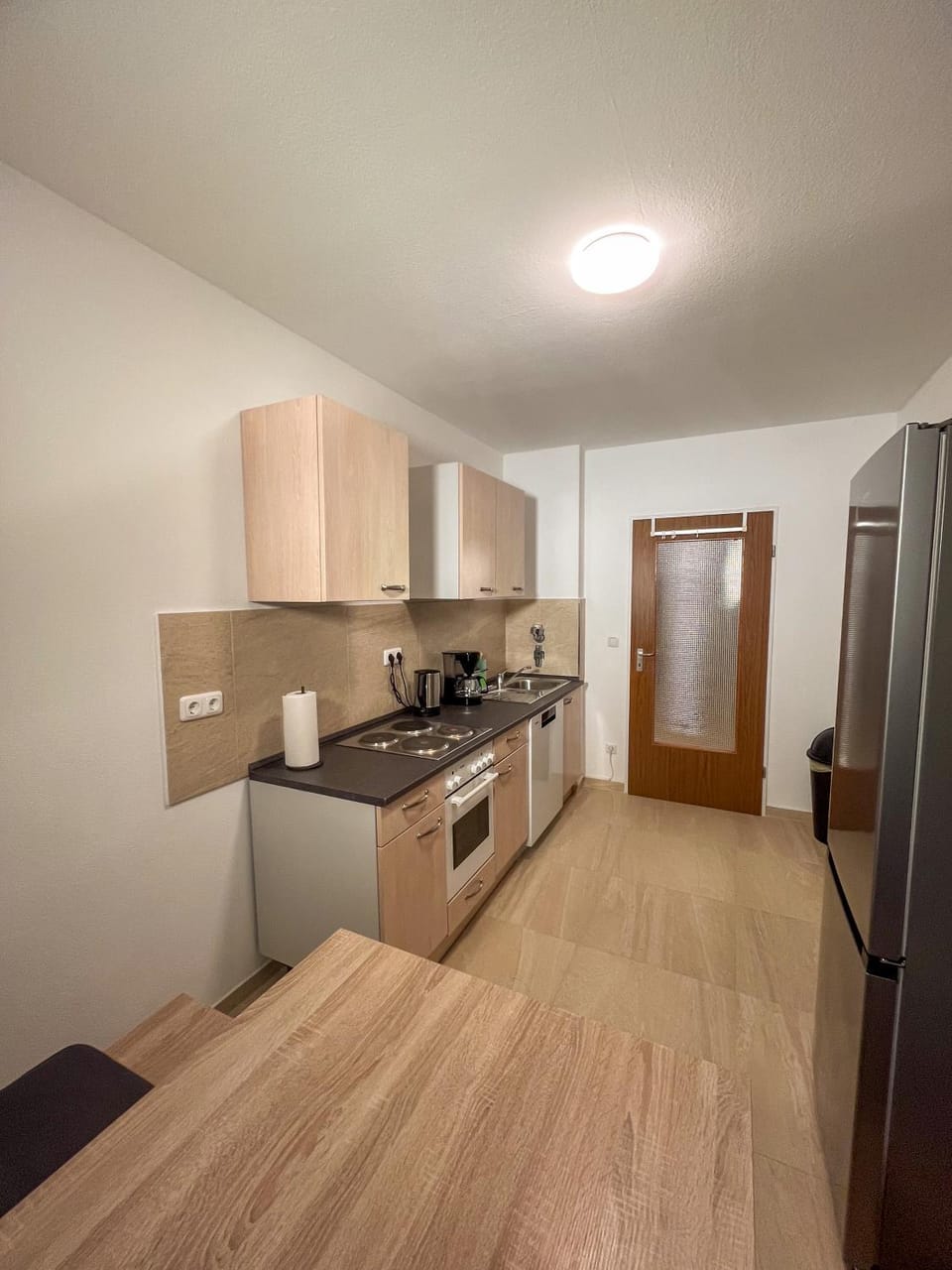 Kitchen or kitchenette, dishwasher, oven, stove