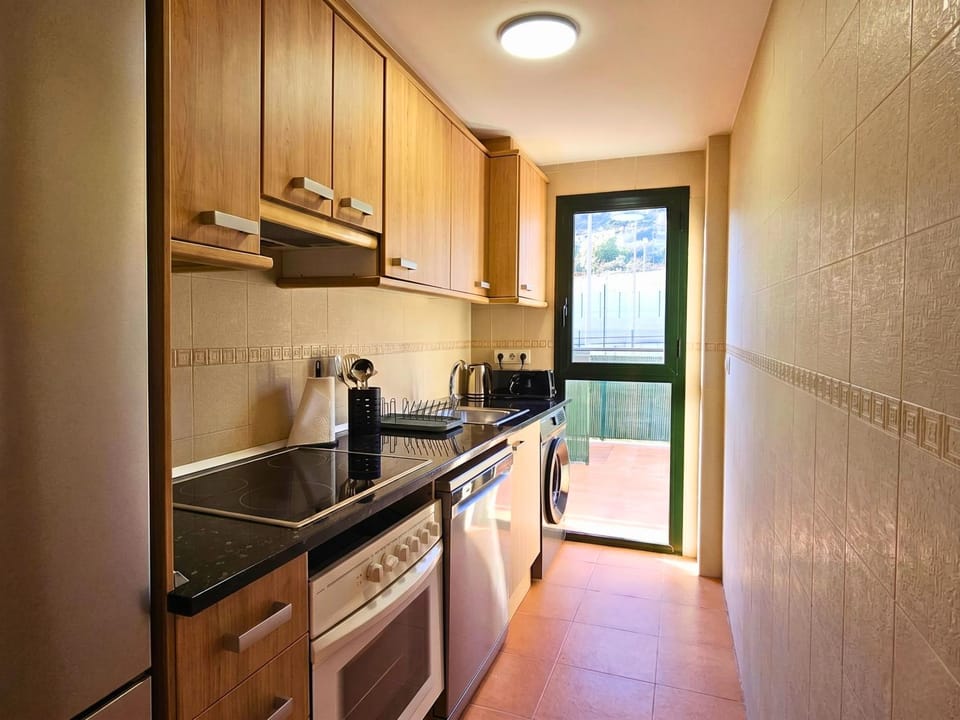 Kitchen or kitchenette, dishwasher, microwave, oven, stove, toaster, washing machine, kitchen