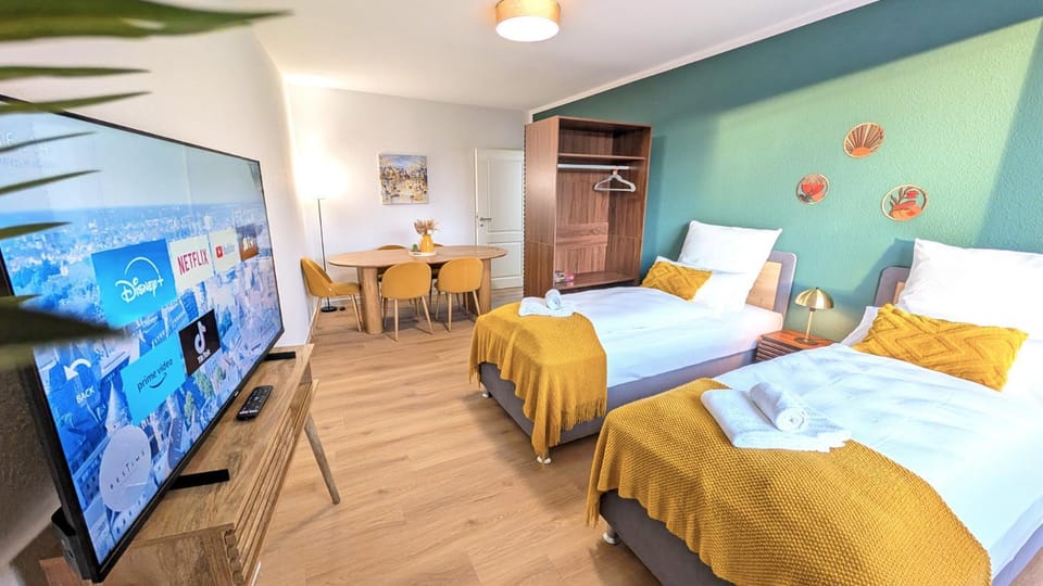 Bed, TV and multimedia, Seating area, Dining area, storage, towels, wardrobe