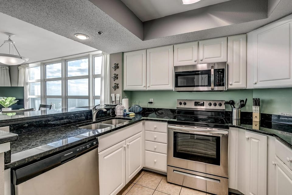 Kitchen or kitchenette, dishwasher, microwave, oven, stove