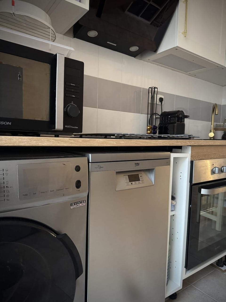 Kitchen or kitchenette, dishwasher, oven, stove, washing machine