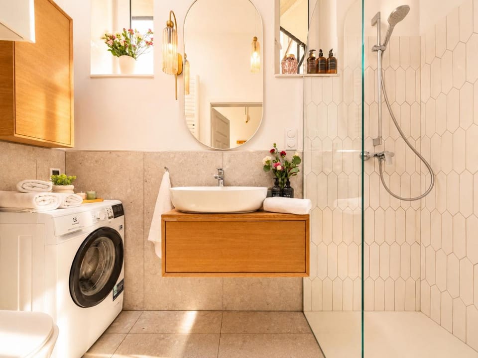 Shower, Toilet, Bathroom, hair dryier, towels, washing machine