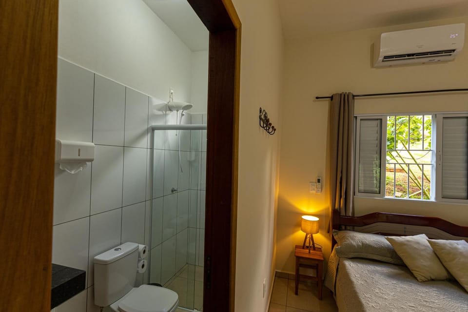 Shower, Toilet, Bed, Bathroom, Photo of the whole room, Bedroom, towels, air conditioner