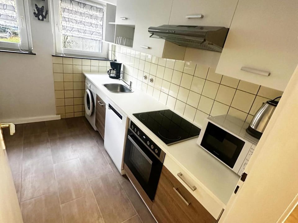 Kitchen or kitchenette, dishwasher, microwave, oven, stove