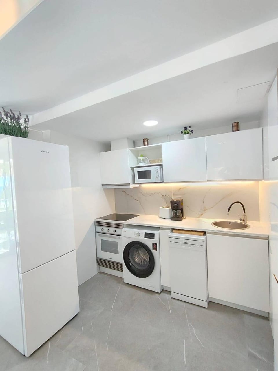 Kitchen or kitchenette, dishwasher, microwave, oven, stove, toaster, washing machine, kitchen