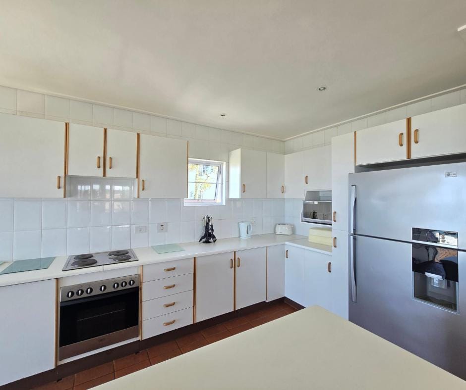 Kitchen or kitchenette, dishwasher, oven, stove, toaster