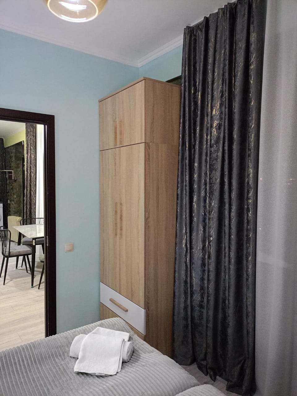 Bed, towels, wardrobe