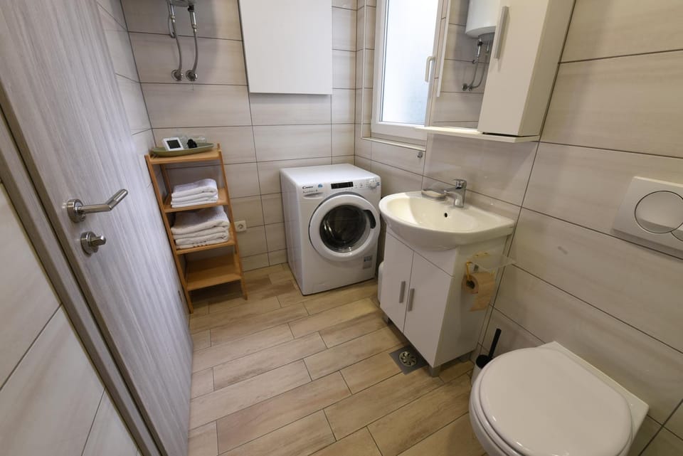 Shower, Toilet, Bathroom, towels, washing machine, dryer