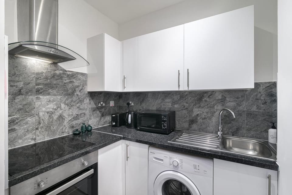 Kitchen or kitchenette, dishwasher, stove, toaster, washing machine