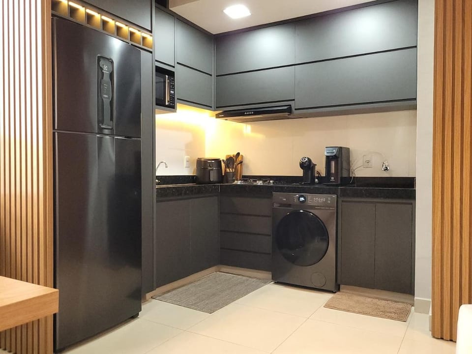 Kitchen or kitchenette, stove, washing machine, dryer