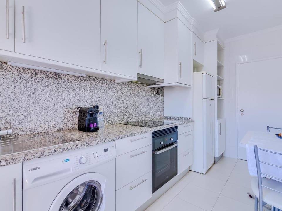 Kitchen or kitchenette, oven, stove, toaster, washing machine