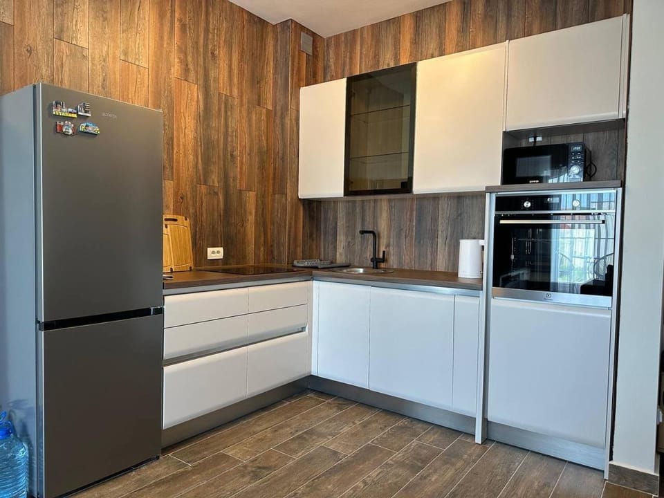 Kitchen or kitchenette, dishwasher, microwave, oven, stove