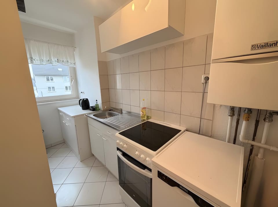 Kitchen or kitchenette, dishwasher, oven, stove