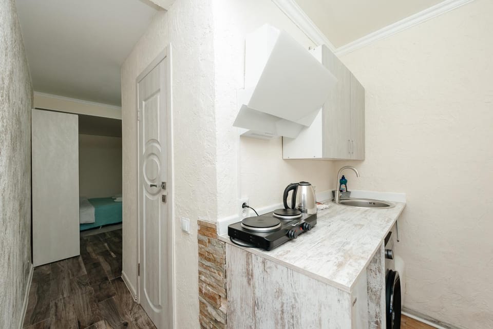 Photo of the whole room, stove, washing machine, kitchen