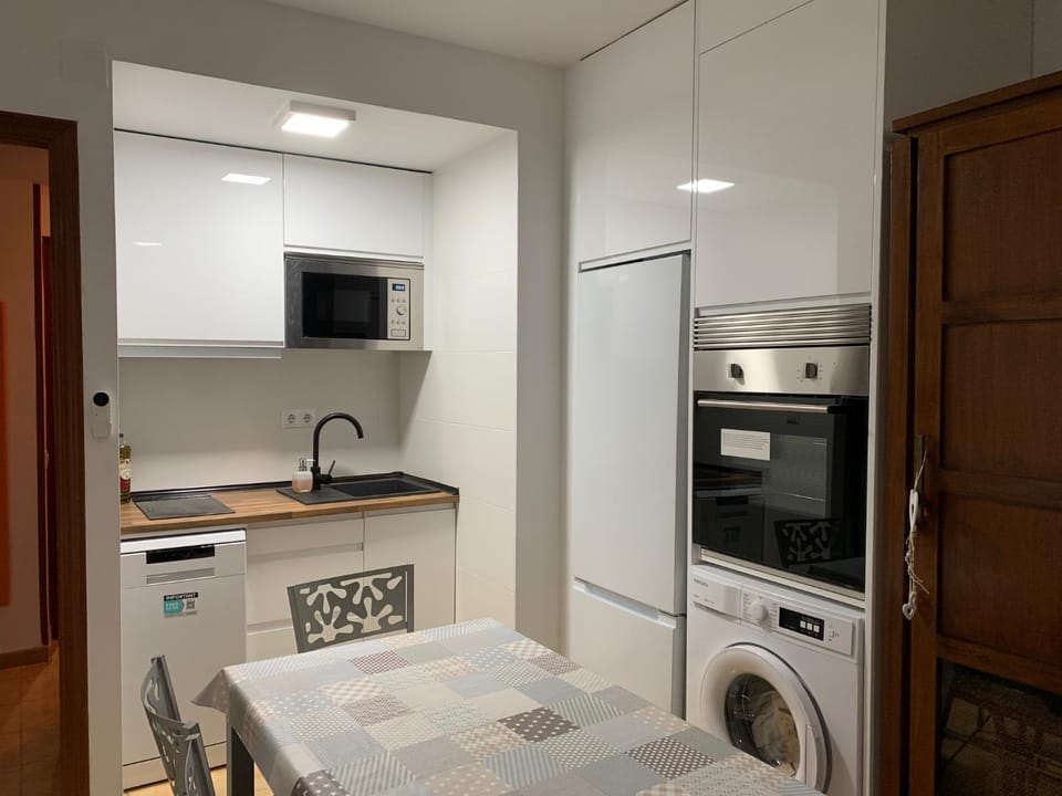 Kitchen or kitchenette, dishwasher, oven, stove, washing machine