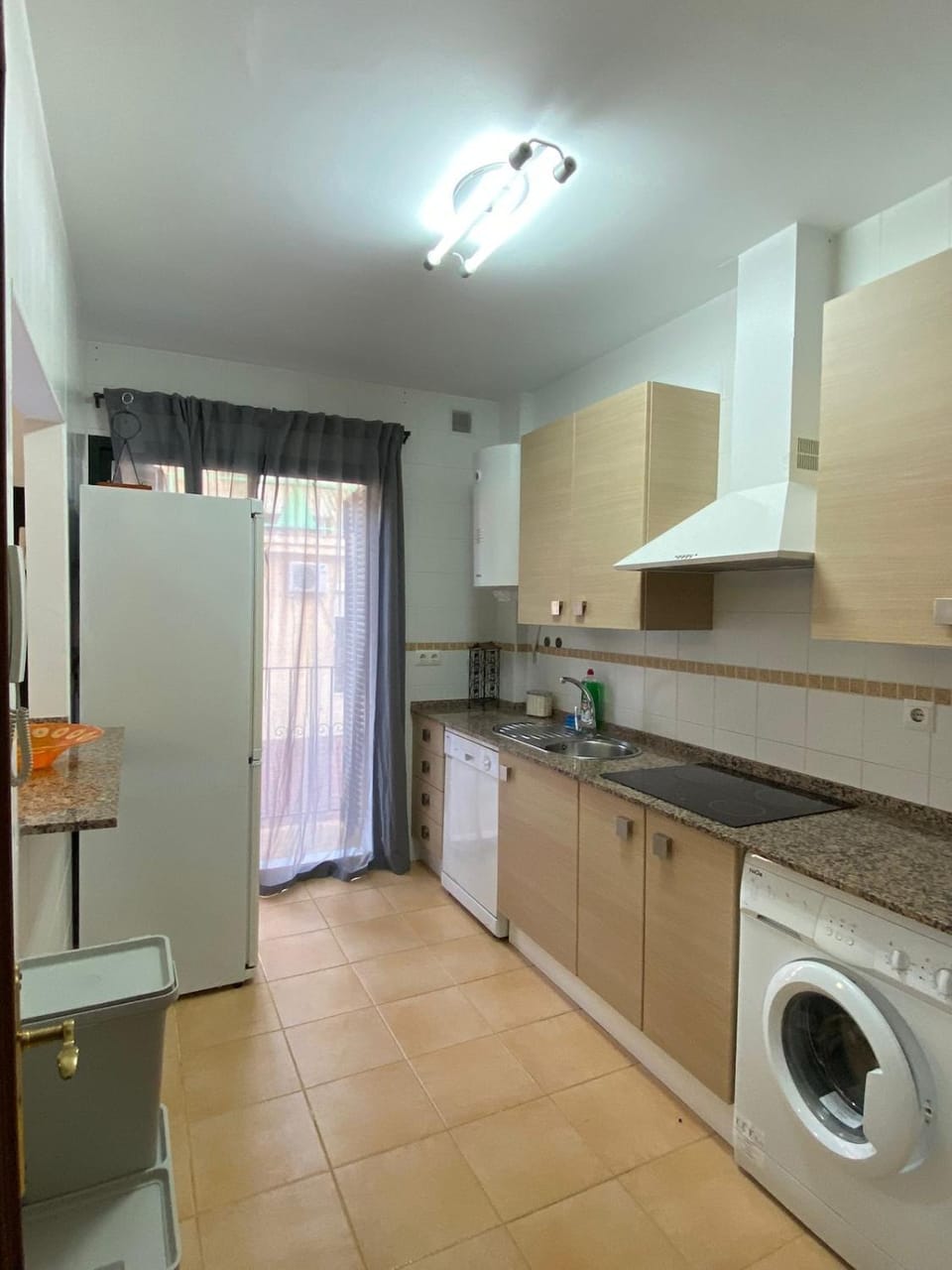 Kitchen or kitchenette, dishwasher, stove, washing machine