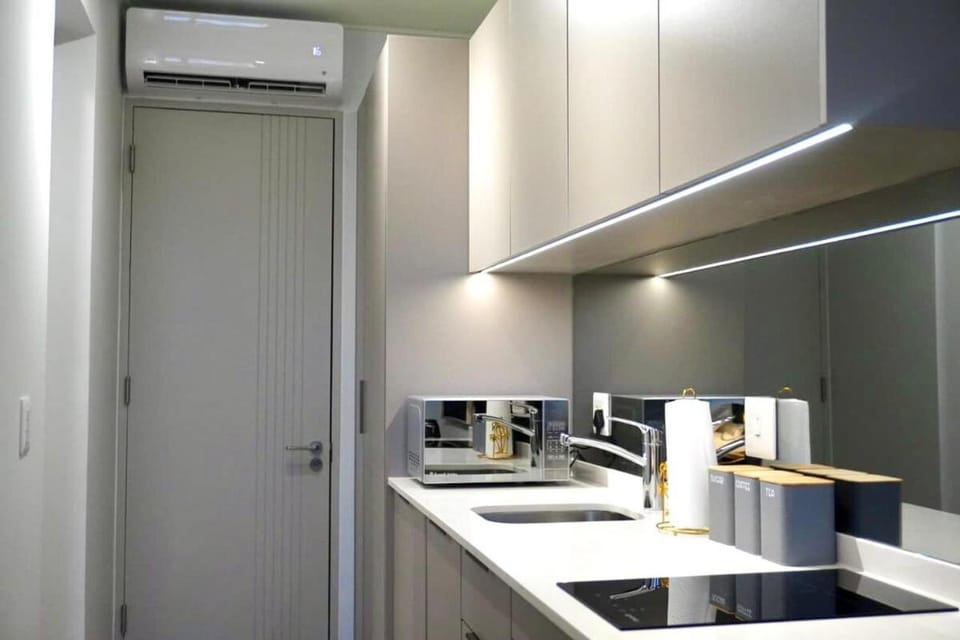 Kitchen or kitchenette, oven, stove, toaster, air conditioner