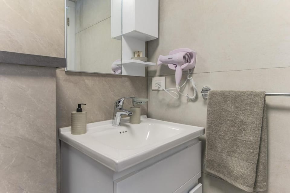 Toilet, Bathroom, hair dryier, towels